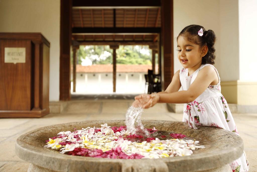 Heritage Madurai Exterior photo A girl playing with flowers
